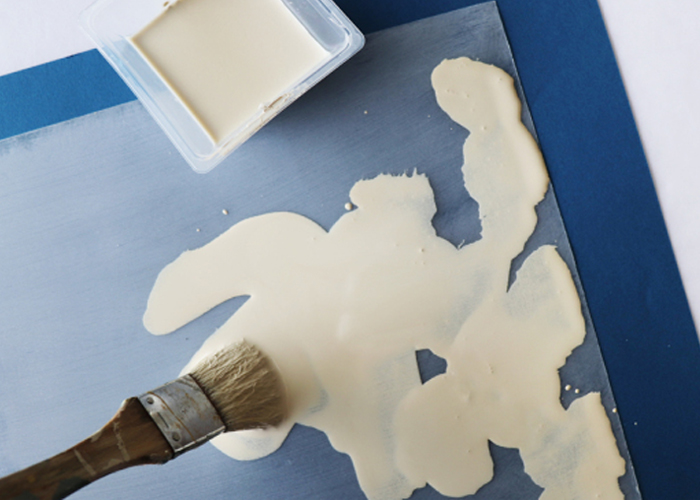 水で薄めたミルクペイントのクリームバニラをまだらに塗る