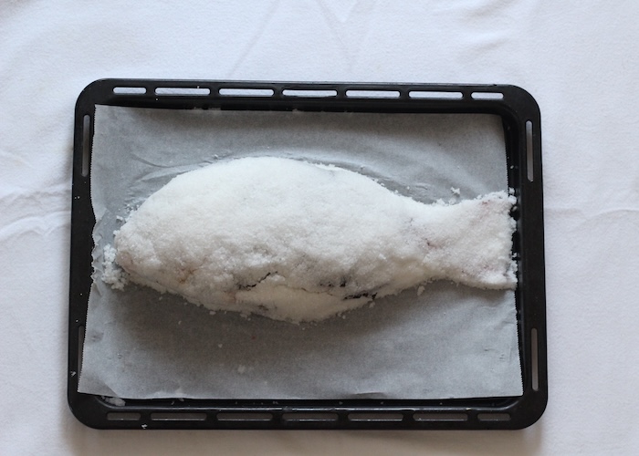 「鯛の塩釜焼き」のつくり方　卵白を加えた粗塩で鯛を覆う